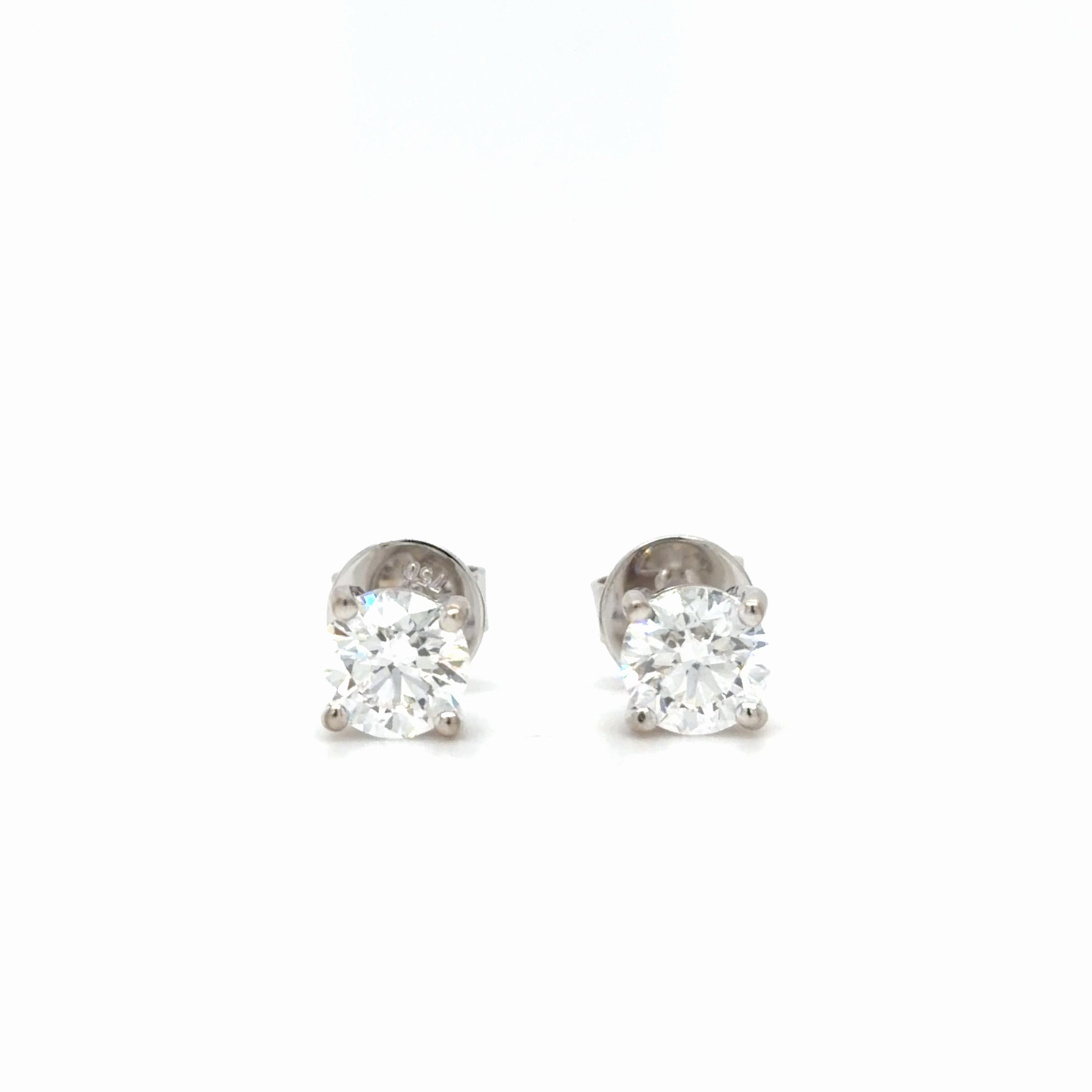 Pair of diamond stud earrings on a white background