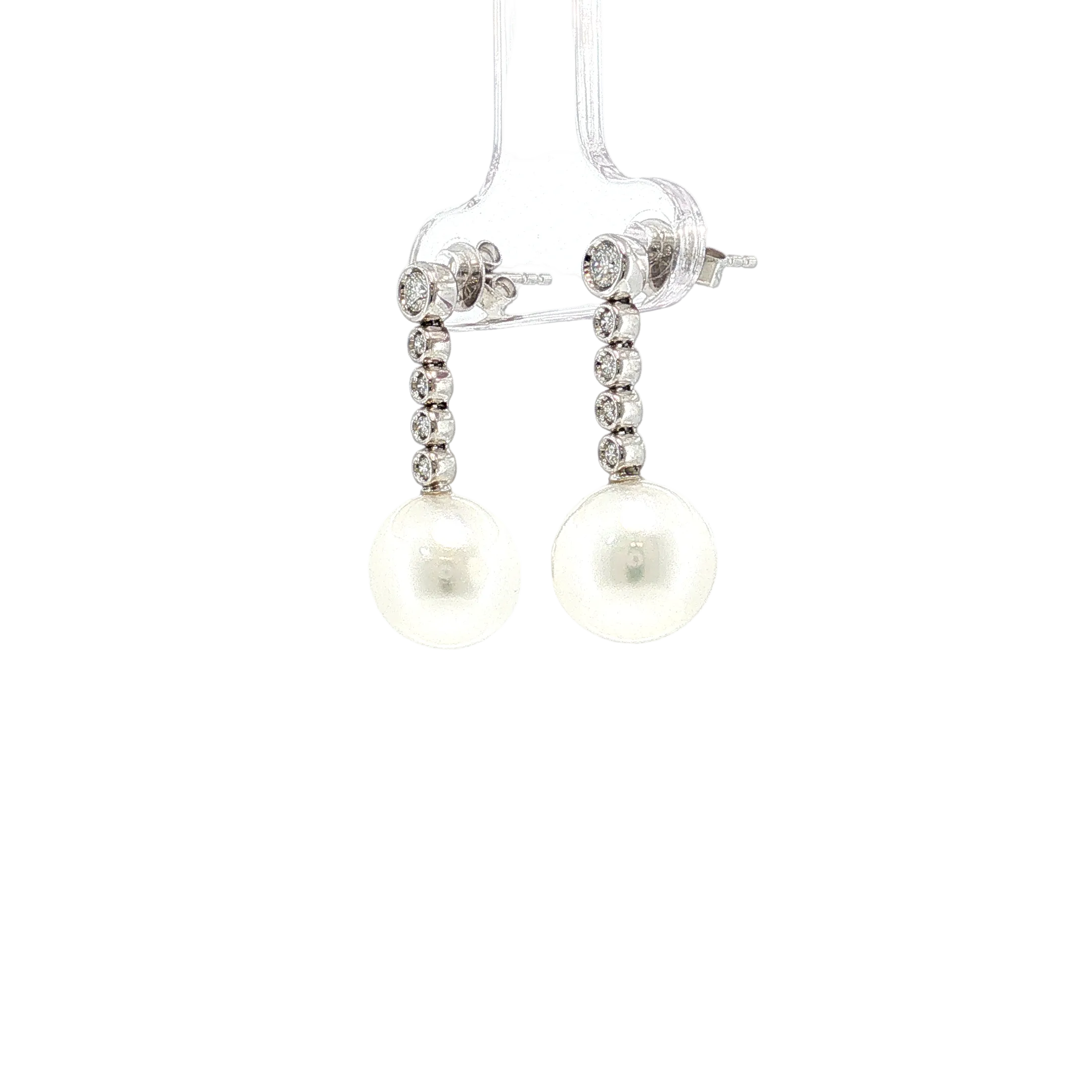 Pearl and diamond earrings on a white background