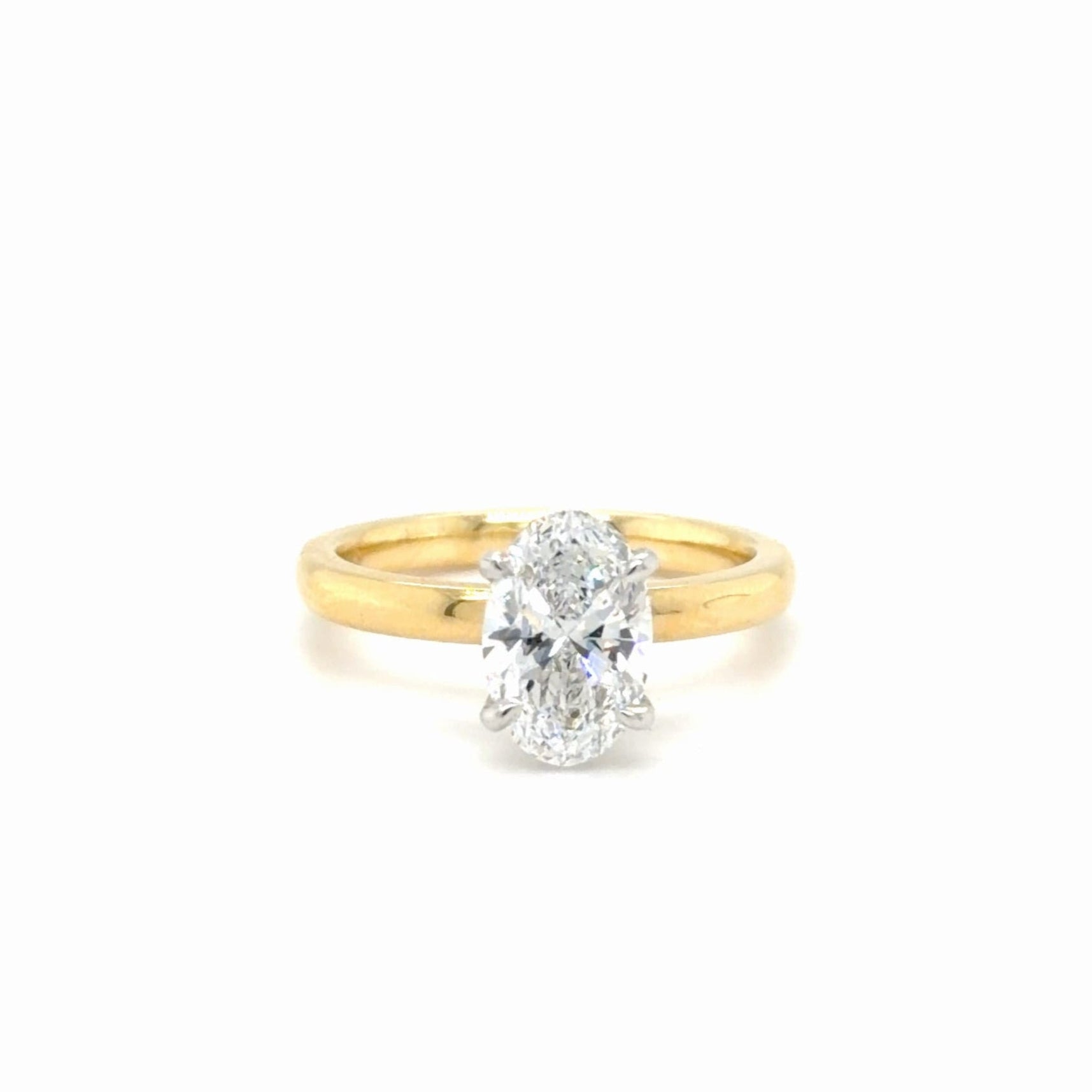 Gold ring with a diamond on a white background